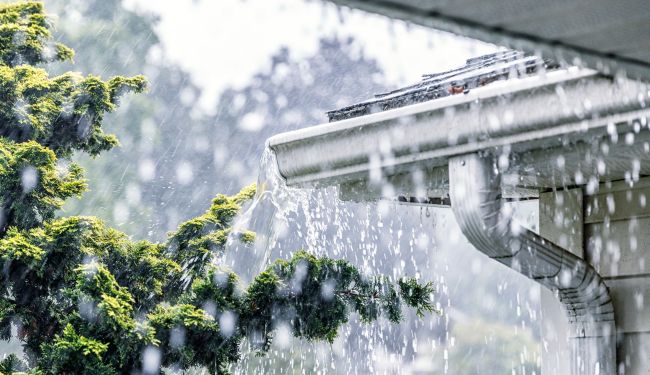 Gutters overflowing with rainwater.