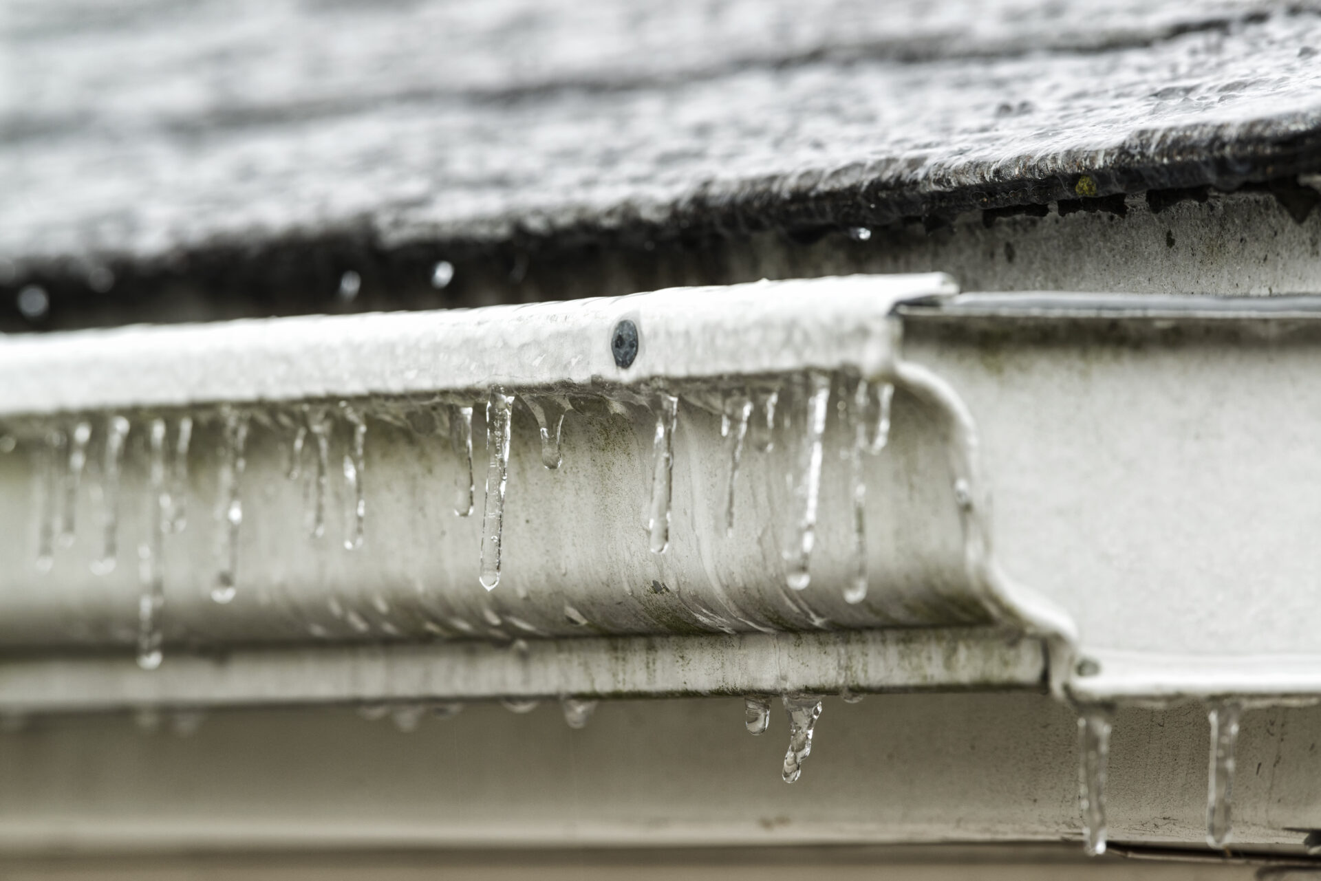 Ice forming on residential gutters after a winter rainstorm