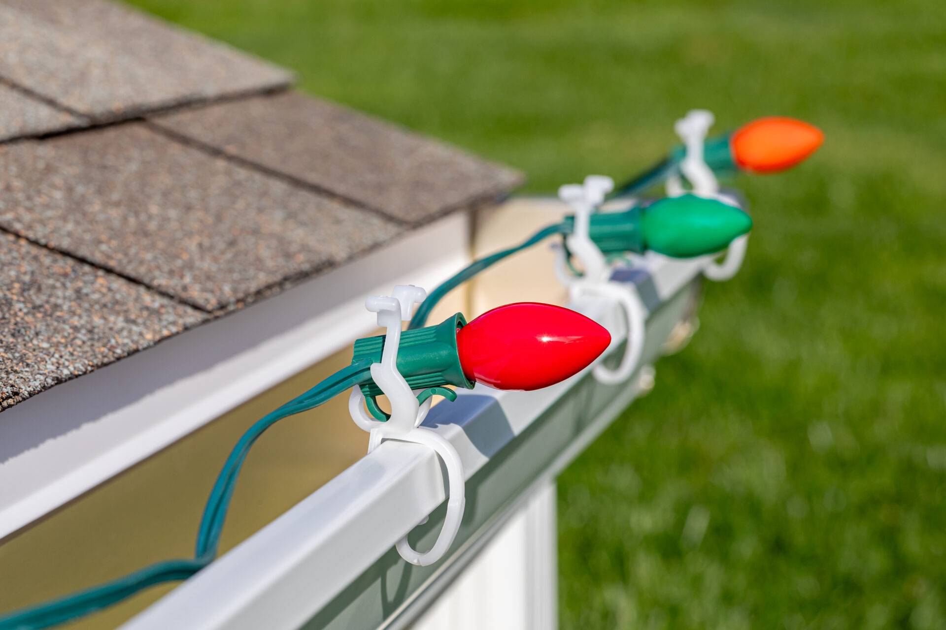 Christmas lights clipped to residential gutters