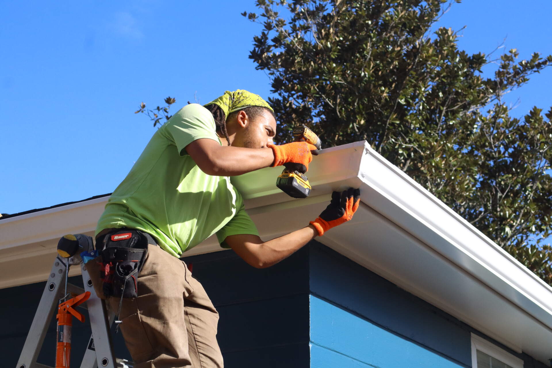 Holy City Gutterworks team member installing new gutters on a Charleston home.